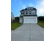 Charming two-story home with a two-car garage and manicured lawn, perfect for suburban living at 242 Torslanda Ln, Summerville, SC 29486