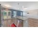 Kitchen island with sink, dishwasher, granite countertops, and doors leading to the back deck at 242 Torslanda Ln, Summerville, SC 29486