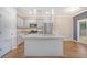 Bright, modern kitchen featuring granite countertops, stainless appliances, and stylish pendant lighting at 242 Torslanda Ln, Summerville, SC 29486