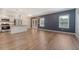 Open-concept living room and kitchen with stainless steel appliances and hardwood floors at 242 Torslanda Ln, Summerville, SC 29486