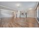 Expansive open-concept space with hardwood floors connecting the living room and modern kitchen at 242 Torslanda Ln, Summerville, SC 29486