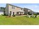 Beautiful backyard featuring a cozy fire pit area, patio with seating, and lush green grass at 255 Decatur Dr, Summerville, SC 29486