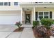 Inviting covered porch with stylish black door and manicured landscaping, creating a welcoming entrance at 255 Decatur Dr, Summerville, SC 29486