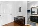 Hallway with bench seat that leads to a half bath, featuring hardwood floors and white trim at 255 Decatur Dr, Summerville, SC 29486
