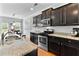 Well-equipped kitchen with dark cabinetry, granite countertops, and stainless steel appliances at 255 Decatur Dr, Summerville, SC 29486