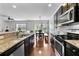 A spacious kitchen showcases dark cabinets, stainless appliances, granite counters, and hardwood floors at 255 Decatur Dr, Summerville, SC 29486