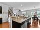 Open-concept kitchen with a large island, modern lighting, and stainless steel appliances at 255 Decatur Dr, Summerville, SC 29486