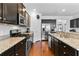 A spacious kitchen features dark cabinetry, granite countertops, and stainless steel appliances at 255 Decatur Dr, Summerville, SC 29486