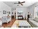 Bright living room featuring hardwood floors, yellow area rug, ceiling fan and comfortable gray sofas and love seat at 255 Decatur Dr, Summerville, SC 29486
