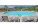Resort-style community swimming pool featuring lounge chairs, umbrellas, and ample space for sunbathing at 255 Decatur Dr, Summerville, SC 29486