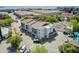 Bird's eye view of a light grey apartment with balconies, a parking area, and lush greenery in a prime location at 259 E Bay St # 7C, Charleston, SC 29401