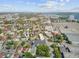 Overhead view reveals a light grey apartment nestled amidst a diverse landscape of colorful architecture and Charleston's waterfront at 259 E Bay St # 7C, Charleston, SC 29401