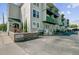 Apartment building exterior with balconies and a brick wall with an entrance sign at 259 E Bay St # 7C, Charleston, SC 29401