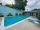 Inviting in-ground pool with clear blue water, surrounded by lush greenery and relaxing lounge chairs at 259 E Bay St # 7C, Charleston, SC 29401