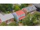 A charming blue home with a red roof and front porch nestled among lush greenery and neighboring houses at 293 Grove St, Charleston, SC 29403