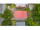 Aerial view of a home with a red metal roof surrounded by lush greenery and neighboring houses, showcasing the property's location at 293 Grove St, Charleston, SC 29403
