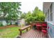 Backyard featuring a lush lawn, wooden deck, storage shed, and decorative fence, perfect for relaxation at 293 Grove St, Charleston, SC 29403