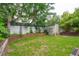 Grassy backyard with wooden raised garden beds and a storage shed, offering a peaceful and functional outdoor space at 293 Grove St, Charleston, SC 29403