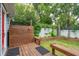 Inviting backyard oasis featuring a wooden deck with outdoor shower, bench seating, and lush landscaping at 293 Grove St, Charleston, SC 29403