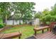 Enjoy the spacious backyard with a lush lawn, wooden deck, and a storage shed for convenience at 293 Grove St, Charleston, SC 29403