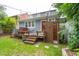 Backyard with a deck, outdoor shower, and a vibrant red door, creating an inviting and functional outdoor living space at 293 Grove St, Charleston, SC 29403
