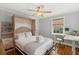 This bedroom features a built-in murphy bed, ceiling fan, and a sunlit desk area with a view at 293 Grove St, Charleston, SC 29403
