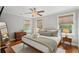 Comfortable bedroom with a ceiling fan, two windows, lots of light and a warm, inviting design at 293 Grove St, Charleston, SC 29403
