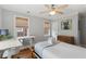 Bright bedroom featuring a ceiling fan, built-in murphy bed, wood floors, and an office nook at 293 Grove St, Charleston, SC 29403