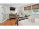 Inviting bedroom featuring hardwood floors, a dedicated workspace, and bright natural light at 293 Grove St, Charleston, SC 29403