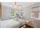 Well-lit bedroom featuring a ceiling fan, desk area, and neutral decor at 293 Grove St, Charleston, SC 29403
