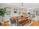Charming dining area features a rustic wooden table, bench seating, and an abundance of natural light from large windows at 293 Grove St, Charleston, SC 29403