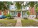 Inviting home with a welcoming front porch, featuring a bright red door and a quaint seating area at 293 Grove St, Charleston, SC 29403