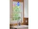 Farmhouse sink is complimented by natural light and an accent backsplash at 293 Grove St, Charleston, SC 29403