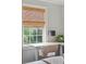 Cozy home office nook with built-in desk, lots of natural light and a comfortable chair at 293 Grove St, Charleston, SC 29403
