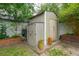 Backyard featuring storage sheds, landscaping, potted plants, and greenery, providing storage and outdoor charm at 293 Grove St, Charleston, SC 29403