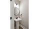 Half bath featuring a pedestal sink, black fixtures, and neutral paint at 2960 Blackfish Rd, Johns Island, SC 29455
