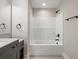 Bathroom featuring dark cabinets, a marble vanity and bathtub with shower at 2960 Blackfish Rd, Johns Island, SC 29455