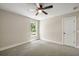 A serene bedroom features neutral walls, plush carpet, a window with a view, and a convenient closet at 2960 Blackfish Rd, Johns Island, SC 29455