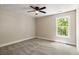 A bright bedroom features neutral walls, plush carpet, a ceiling fan, and a window with natural light at 2960 Blackfish Rd, Johns Island, SC 29455