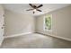 A light bedroom has neutral walls, gray carpet, a ceiling fan, and a window that lets in natural light at 2960 Blackfish Rd, Johns Island, SC 29455