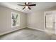 Bright bedroom shows neutral walls, gray carpet, a ceiling fan, and a window that looks outside at 2960 Blackfish Rd, Johns Island, SC 29455