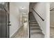 Bright hallway featuring wood floors, stairs leading to the second level, and a view of the backyard at 2960 Blackfish Rd, Johns Island, SC 29455