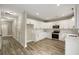 A bright kitchen with white cabinets, stainless steel appliances, subway tile backsplash, and wood-look flooring at 2960 Blackfish Rd, Johns Island, SC 29455