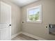 Well-lit laundry room has tile floors, a window, washer hookups, and neutral walls at 2960 Blackfish Rd, Johns Island, SC 29455