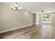 Bright living room with hardwood floors, modern lighting, and large window at 2960 Blackfish Rd, Johns Island, SC 29455
