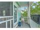 A private covered balcony with a chair and an outdoor lantern offering serene views of the surrounding trees at 300 Foxglove Ave, Summerville, SC 29483