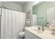 Neutral toned bathroom with white shower curtain and vanity, and shell decorations at 300 Foxglove Ave, Summerville, SC 29483