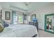 Bright bedroom with a four-poster bed, white bedding, and a balcony entrance with sheer curtains at 300 Foxglove Ave, Summerville, SC 29483