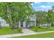 Charming two-story home with a porch and well-maintained lawn surrounded by mature trees at 300 Foxglove Ave, Summerville, SC 29483