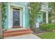 Inviting covered porch with swing seating and lush landscaping at 300 Foxglove Ave, Summerville, SC 29483